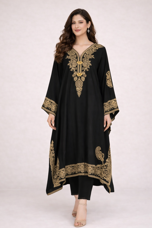 Woman wearing a black embroidered outfit on a white background