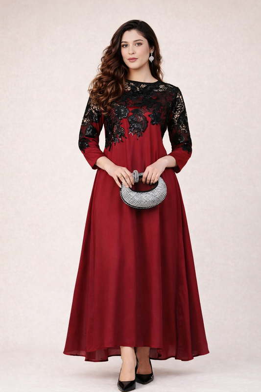 Woman wearing a red and black dress with floral lace details on a white background