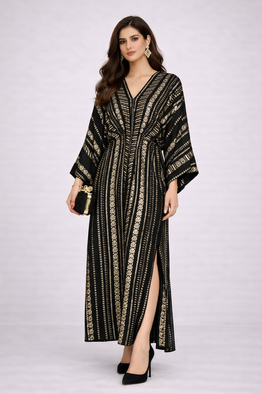 Woman wearing a black and gold patterned dress on a white background