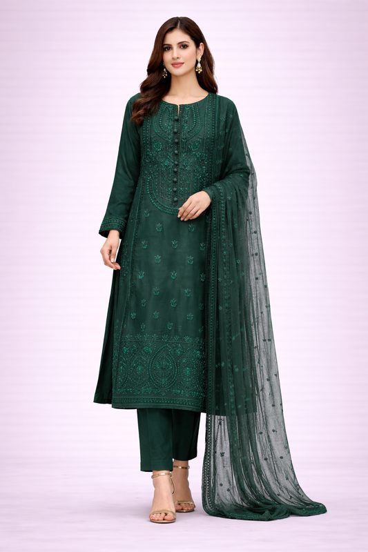 Woman wearing a green embroidered outfit with a matching dupatta on a light purple background