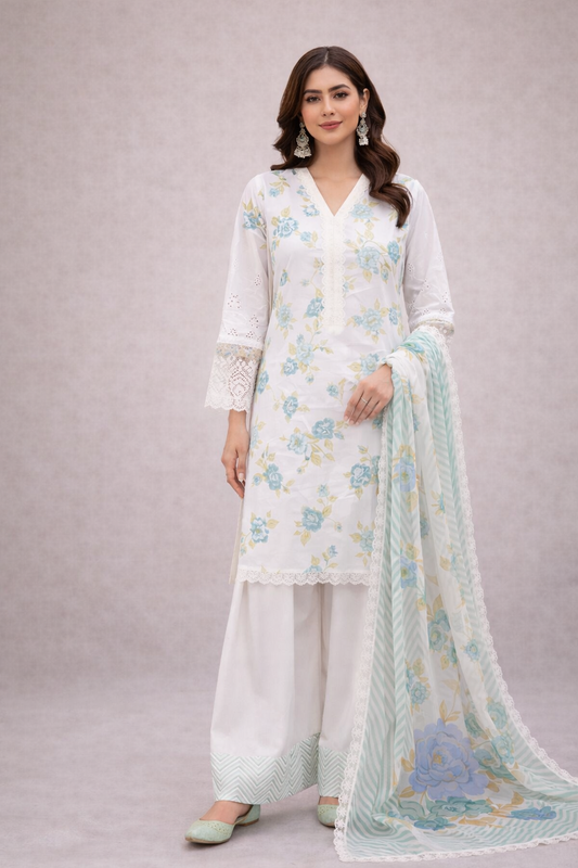 Woman wearing a white floral outfit with a matching dupatta on a light gray background