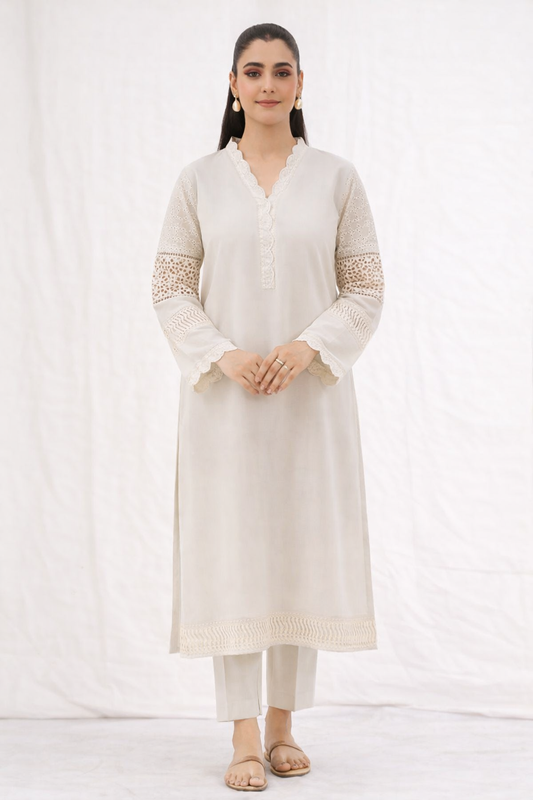 Woman wearing a white kurta with lace details on a white background